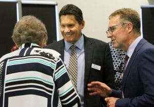 Resthaven CEO Darren Birbeck (centre) and Executive Manager Finance and Technology, David Norton (right) chat with a resident at the meeting.